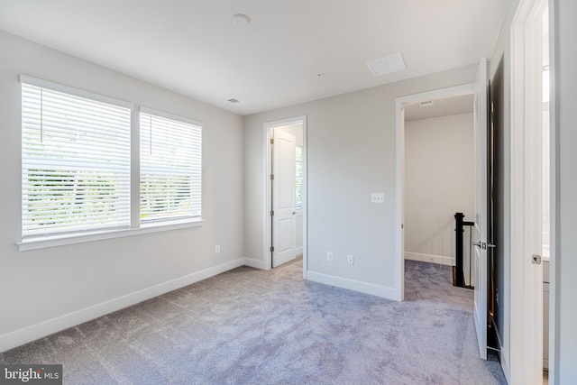 unfurnished bedroom with light carpet