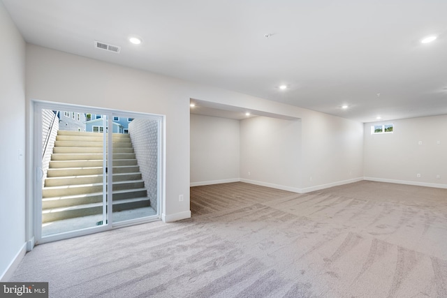 basement featuring light carpet