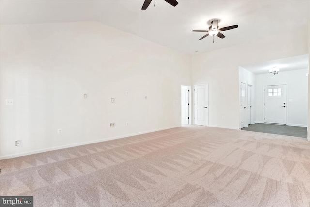 carpeted spare room featuring ceiling fan and lofted ceiling