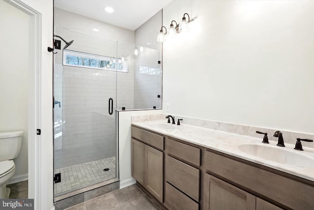 bathroom with vanity, toilet, and walk in shower