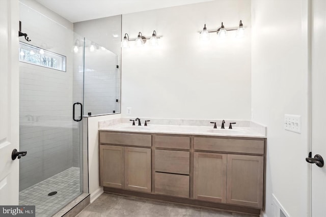 bathroom with vanity and a shower with door