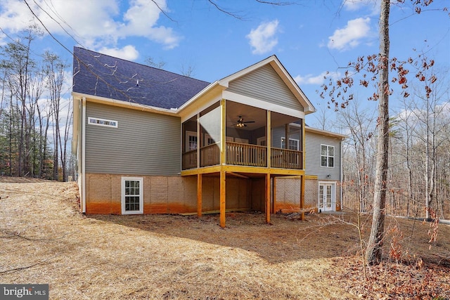 rear view of house featuring a sunroom, ceiling fan, and french doors