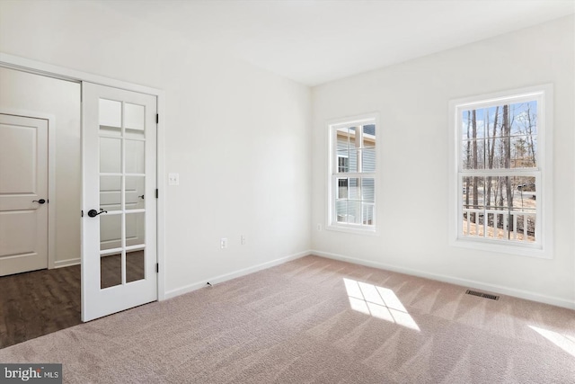 unfurnished room with carpet floors and french doors