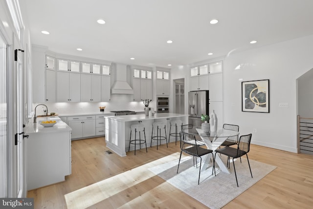 dining room featuring sink and light hardwood / wood-style floors