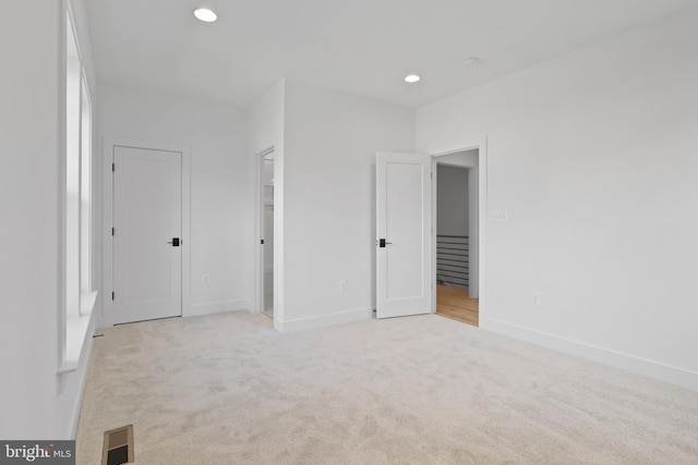 unfurnished bedroom featuring light colored carpet