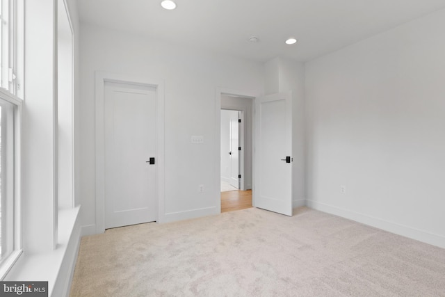 unfurnished bedroom featuring light colored carpet