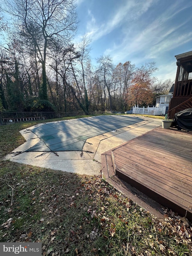 view of swimming pool with a patio area and a wooden deck