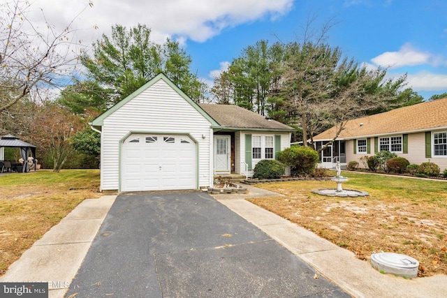 single story home featuring a front yard, a gazebo, and a garage