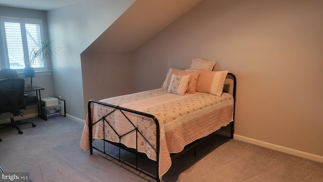 carpeted bedroom featuring vaulted ceiling