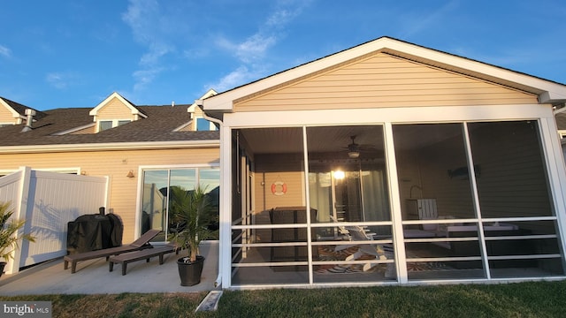 back of house featuring a sunroom