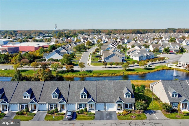 birds eye view of property with a water view and a residential view