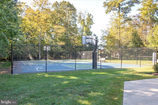 view of sport court featuring community basketball court, fence, and a yard