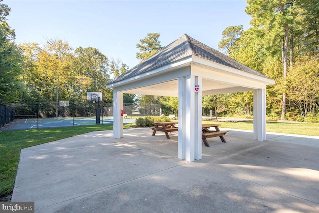 surrounding community featuring a tennis court, community basketball court, a gazebo, and fence