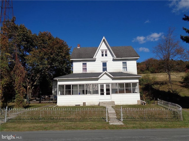 view of front of home featuring a sunroom