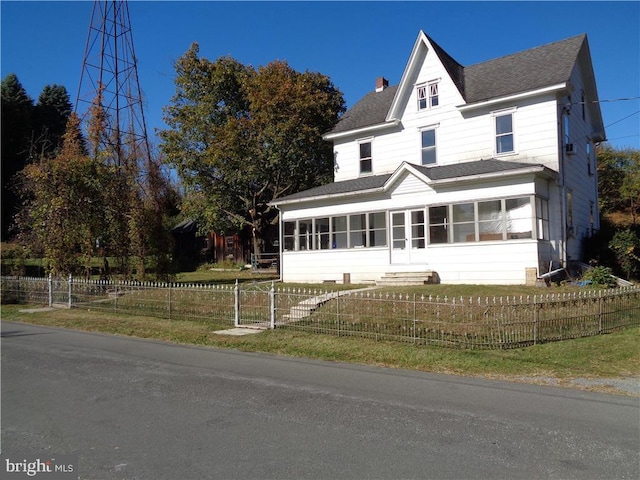 view of front of house featuring a sunroom