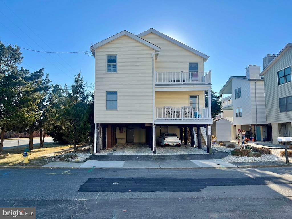 view of front facade featuring a carport and a balcony