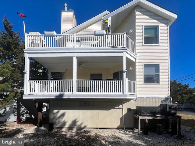 back of property featuring a balcony and central AC unit