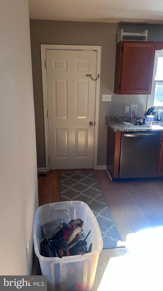 kitchen featuring wood-type flooring and stainless steel dishwasher