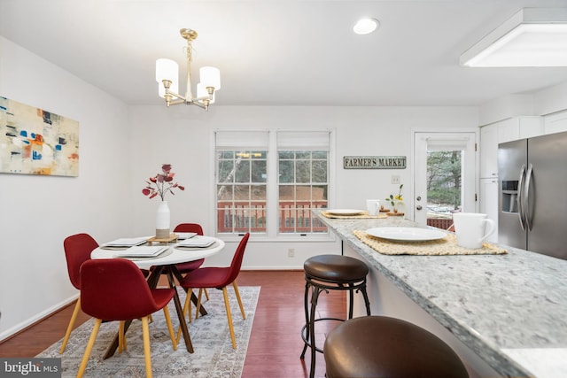 dining space featuring an inviting chandelier, baseboards, dark wood-type flooring, and recessed lighting