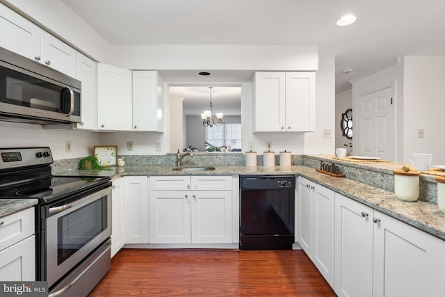 kitchen with stainless steel appliances, a sink, white cabinets, light stone countertops, and dark wood-style floors