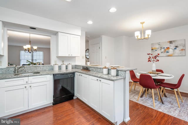 kitchen with a chandelier, dishwasher, a peninsula, and a sink