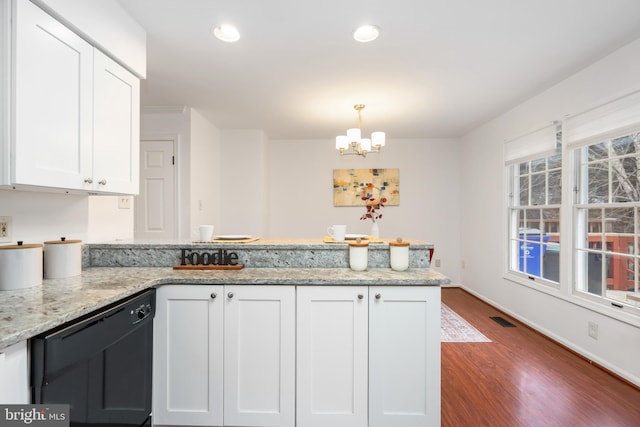 kitchen with black dishwasher, light stone countertops, visible vents, and white cabinets