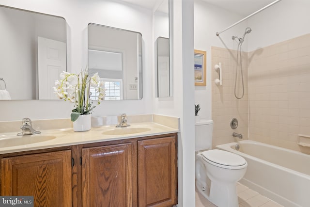 bathroom featuring tile patterned floors, double vanity, a sink, and shower / bathtub combination