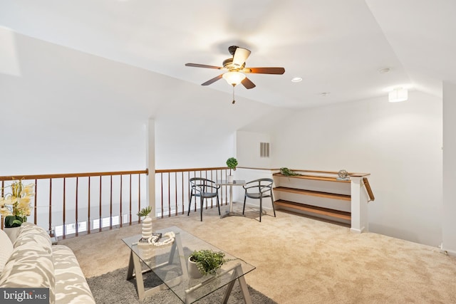 sitting room featuring a ceiling fan, lofted ceiling, light colored carpet, and visible vents