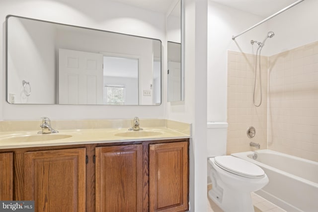 full bathroom with double vanity, toilet, a sink, and shower / bathing tub combination