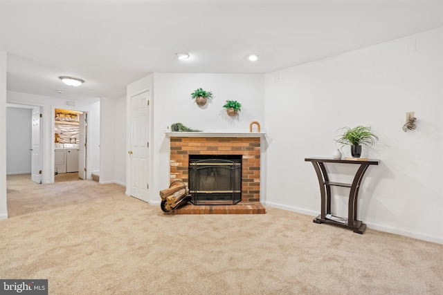 carpeted living room featuring a fireplace and baseboards