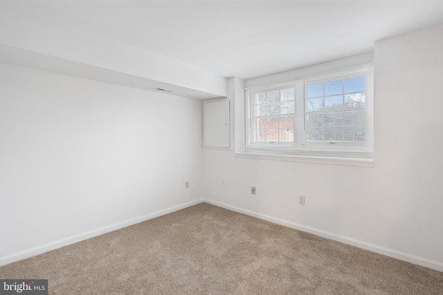 carpeted empty room with visible vents and baseboards