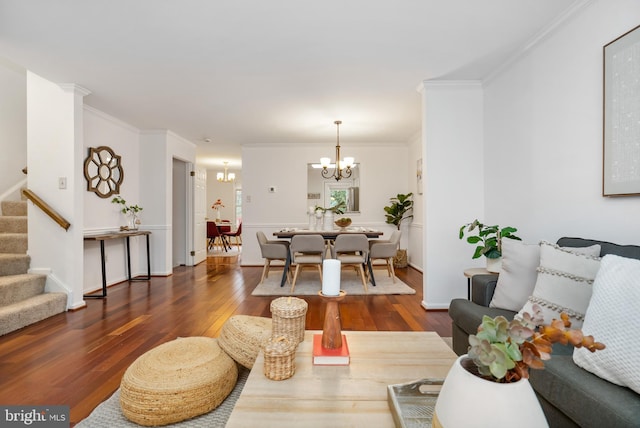 living room featuring a chandelier, baseboards, stairway, dark wood-style floors, and crown molding