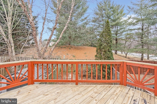 wooden terrace featuring fence