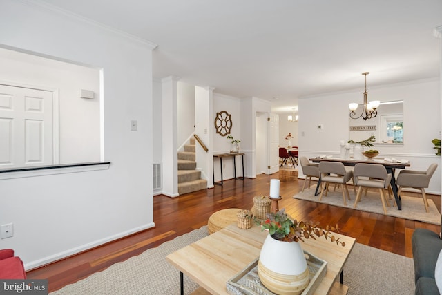 living room featuring visible vents, dark wood-type flooring, stairs, crown molding, and a notable chandelier