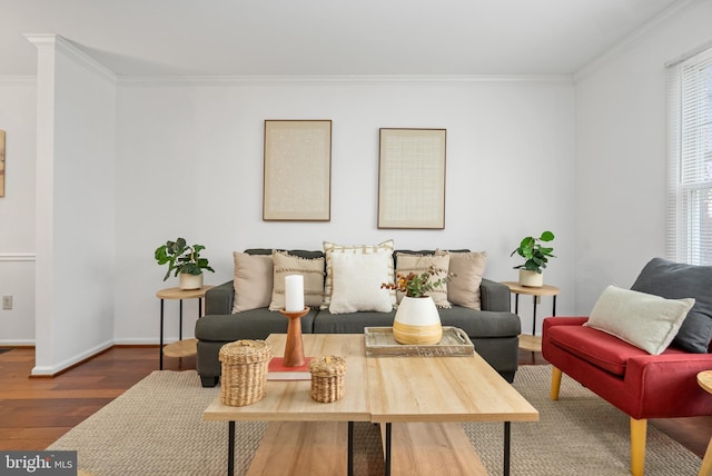 living room with ornamental molding, wood finished floors, and baseboards