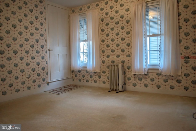 interior space featuring carpet flooring and radiator heating unit