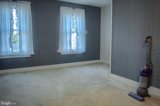 unfurnished room featuring carpet flooring and plenty of natural light