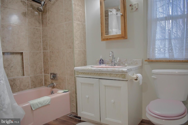 full bathroom with vanity, hardwood / wood-style flooring, toilet, and shower / tub combo with curtain