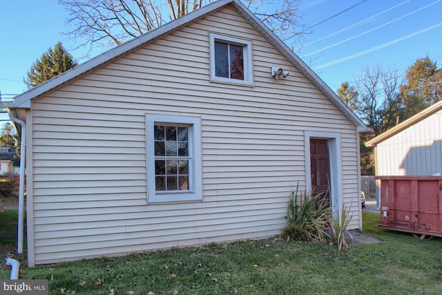 back of property with an outdoor structure and a yard