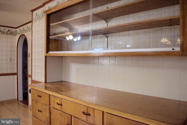 kitchen with ceiling fan, light hardwood / wood-style floors, and ornamental molding