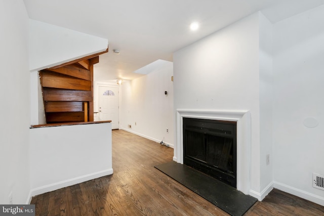 unfurnished living room featuring dark hardwood / wood-style floors