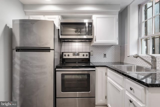 kitchen featuring white cabinetry, sink, a healthy amount of sunlight, and appliances with stainless steel finishes