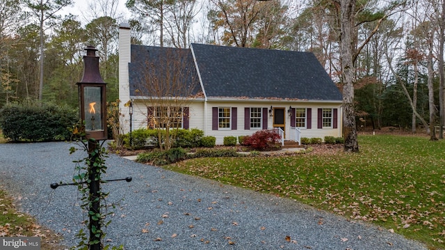 cape cod-style house with a front lawn