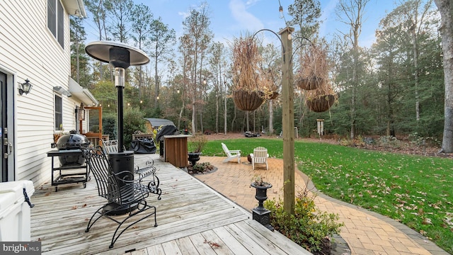 wooden terrace featuring a lawn