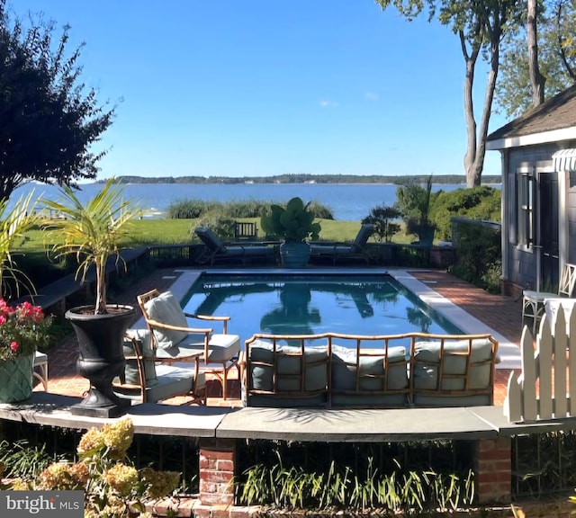 view of pool featuring a water view