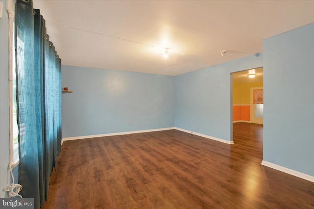 spare room featuring dark hardwood / wood-style flooring