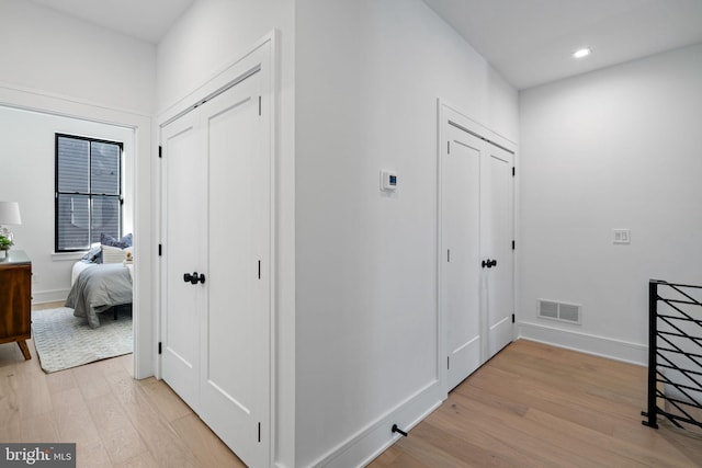 hallway with light wood-type flooring