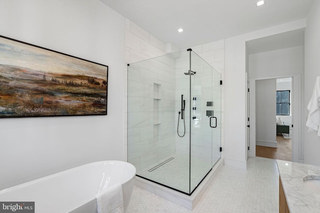 bathroom with tile patterned flooring, shower with separate bathtub, and vanity