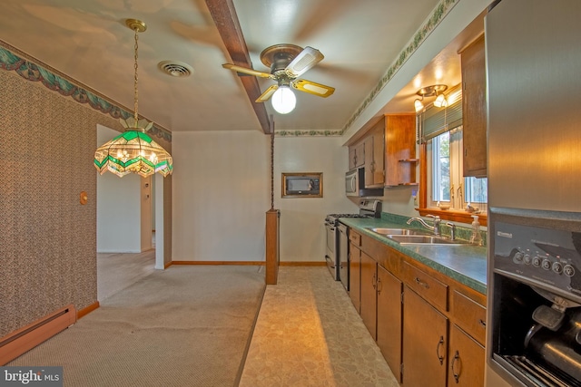 kitchen featuring light carpet, a baseboard heating unit, sink, ceiling fan, and appliances with stainless steel finishes