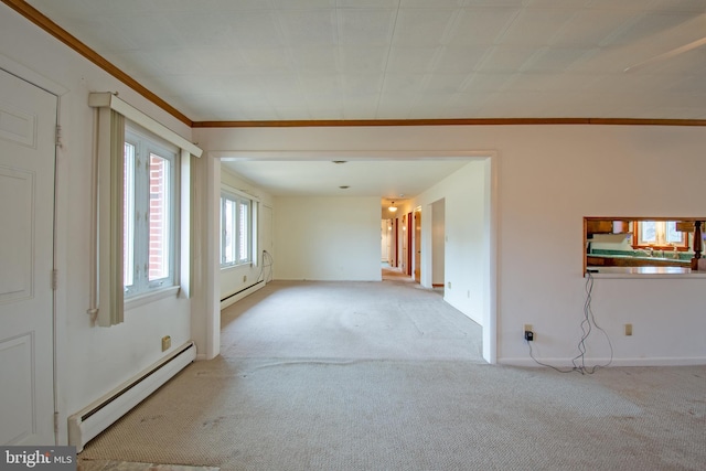 carpeted empty room with baseboard heating and ornamental molding